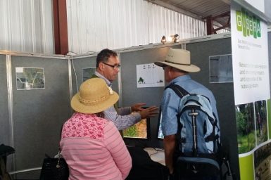Researcher and community members at Farm Fest