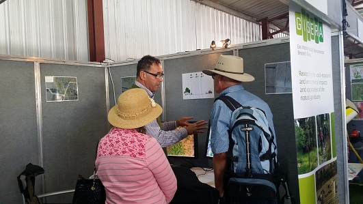 Researcher and community members at Farm Fest